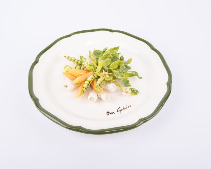 Eva Gordon. Rounded Shape Ceramic Plate Designed with Vegetables