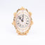 Artistiche Ceramiche Fiorentine. Gilded Oval Clock with Floral Motifs. Medium Size